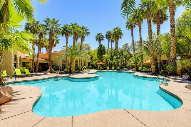 Unwind by the breathtaking pool at Spanish Wells, surrounded by lush palm trees and vibrant landscaping. This serene oasis is perfect for relaxation and entertainment. Schedule your tour today to see it in person!