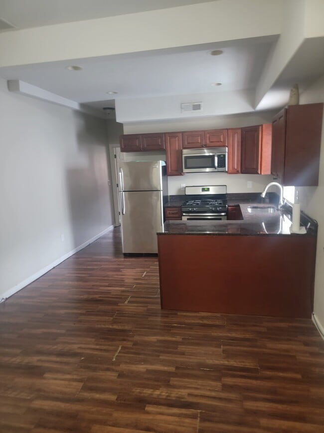 Eat in kitchen with lovely granite countertops gas stove, dishwasher and stainless steel refrigerato - 5201 Germantown Ave Unit Apt 1