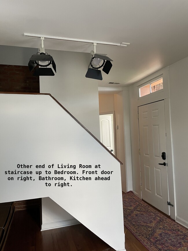 Other end of living room has stairs to 3rd floor bedroom. Entry door to the right - 810 E Washington St