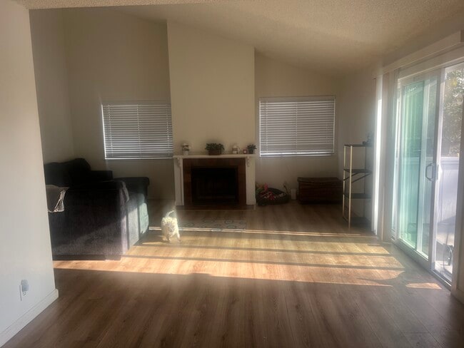 Sunny living room leads to private patio. Living room has beautiful vaulted ceilings - 73 Silcreek Dr Unit 73