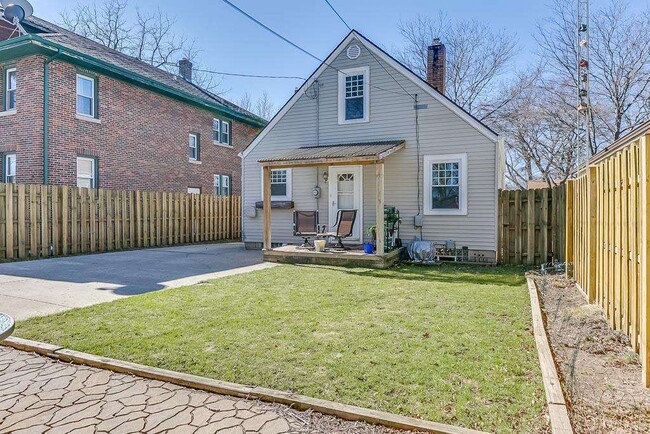 Backyard features fenced yard with covered porch, separate patio, 2 car garage and shed, along with plenty of space for parking
