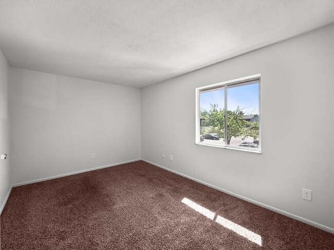 Bedroom with Big Window - Central Square Apartments