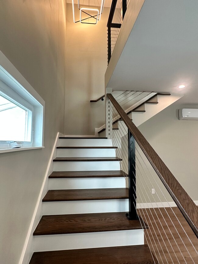Hardwood stairs with modern cable railing - 5642 Printwood Way