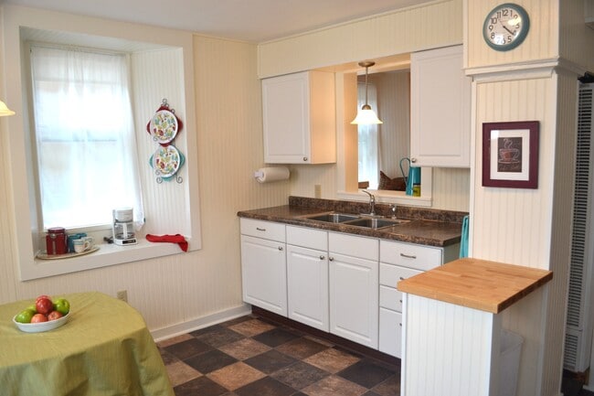 The sink pass-thru looks into the living room. - 222 W Case St Unit apt #1