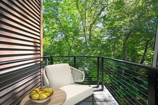 Enjoy serene moments on your private balcony at The Woods at Ambler, an Eagle Rock Community. Surrounded by lush greenery, it's the perfect spot to unwind. Embrace tranquility today—schedule your visit and see it for yourself!