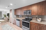 Experience the elegance of modern living with this stylish kitchen and dining setup at Cottonwood Westside Apartment in West Midtown Atlanta