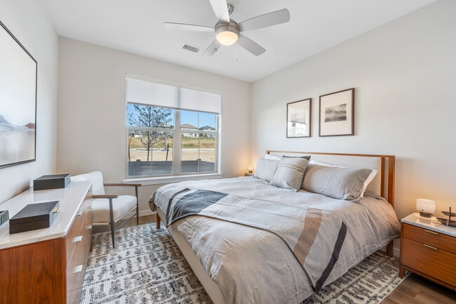 Finish Package I primary bedroom with walk-in closet and hard surface flooring