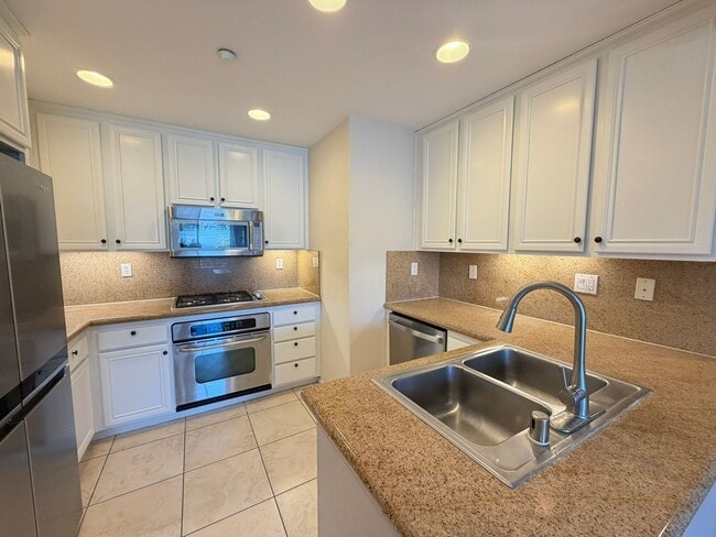 Photo - Sleek 2-Bed with a Den/Office + Flex Corner Condo with Attached Tandem Garage