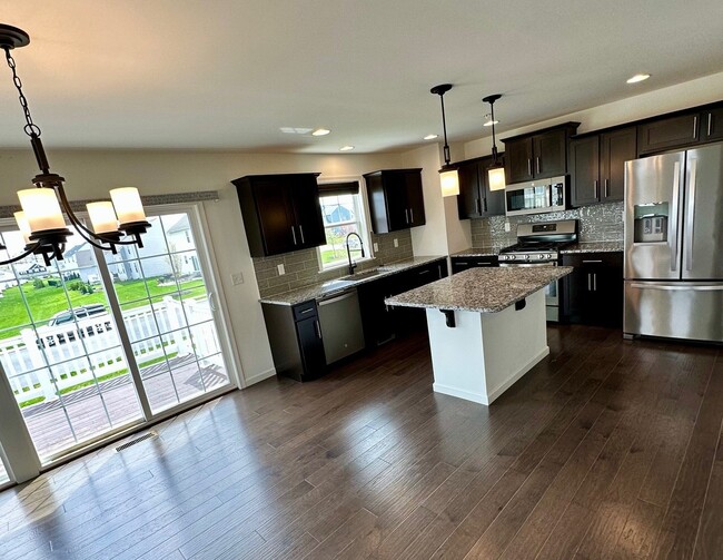 Dining Room/Kitchen looking out the 3-panel slider to deck - 1618 Haralson Dr Townhome