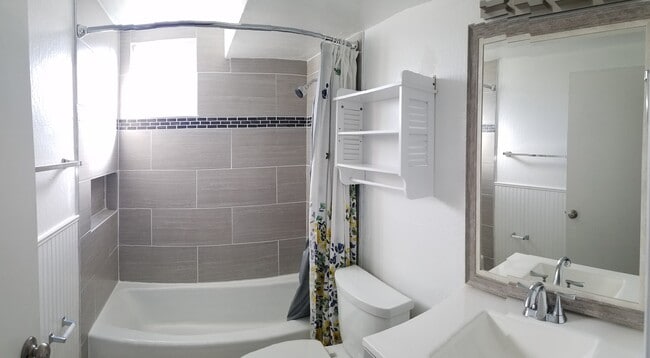 Bathroom just received a nice facelift which includes an updated vanity, low flow toilet, and large format tile shower over tub - 830 Spruce Ct Unit #A