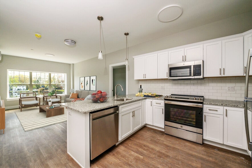 Virtually staged view of kitchen and main living area in 1 & 2 BR unit.