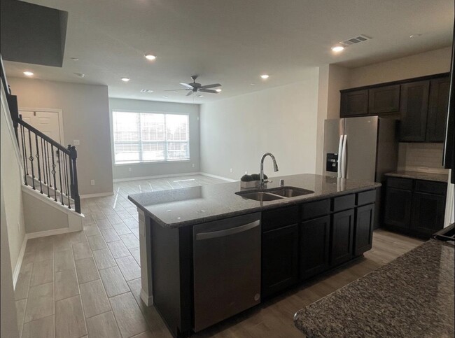 Open concept living room and kitchen - 8036 Scanlan Trl Townhome