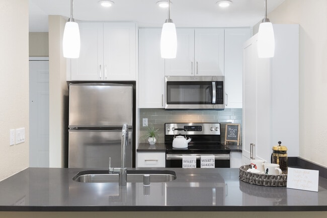 Modern Collection Kitchen With Quartz Countertops Ceramic Tile Backsplash And Stainless Appliances - Avalon Walnut Ridge