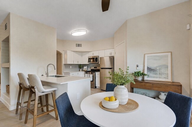 Enjoy modern living at Spanish Ridge, where sophisticated design meets comfort. This inviting kitchen and dining area are perfect for entertaining or relaxing. Don't miss your chance to make this beautifully crafted space your home. Schedule a tour today!