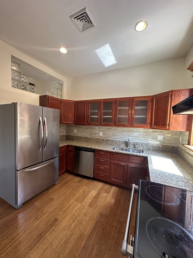 Natural wood cabinetry with glass doors for easy viewing of plates and stemware - 2329 W Grace St Apartments Unit 3