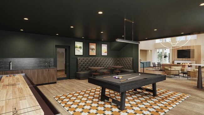 Game room with billiards, shuffleboard, and game tables at Modera Shoreline apartments in Shoreline, WA. - Modera Shoreline