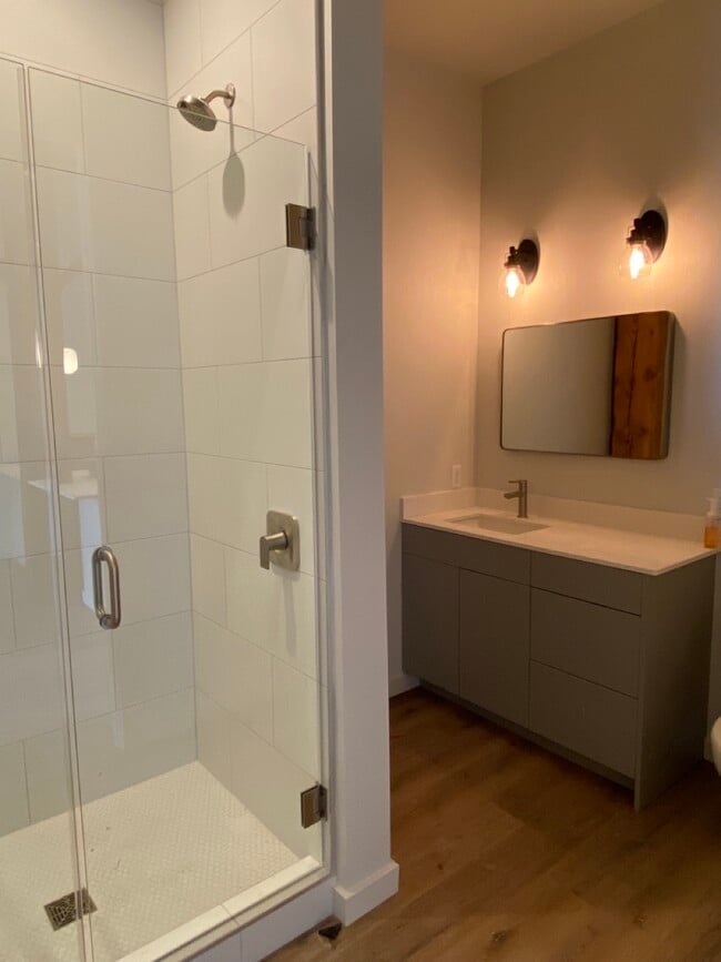 Large Tiled Showers, Glass Doors, Quartz Vanity Countertops