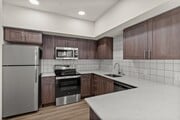 Enjoy cooking in a fully equipped kitchen with sleek stainless steel appliances and generous counter space.