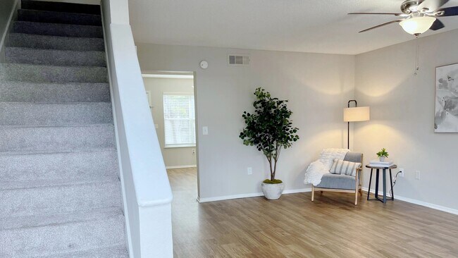 Unwind in fab living spaces where bright wood-style floors, dance under the glow of chic ceiling fans.