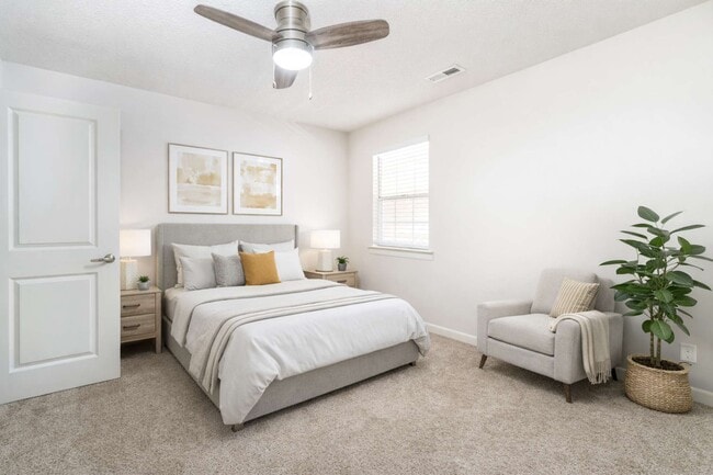 Comfortable bedroom layouts at Sugar Creek Apartments in Winston-Salem, NC feature bright interiors, plush carpeting, and relaxing modern design.