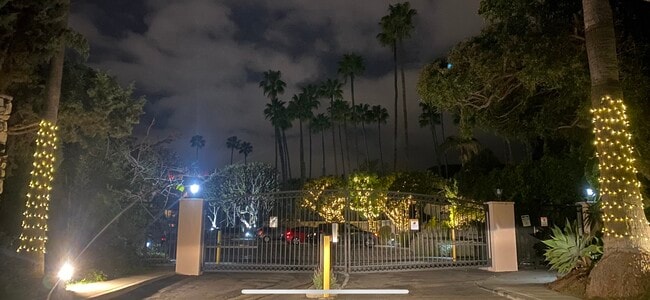 Gated entrance to Brentwood Sunset at night - 241 S Barrington Ave Unit 4