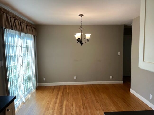 Photo - Beautiful updated home with all stainless steel appliances, hardwood floors throughout, and a lar...