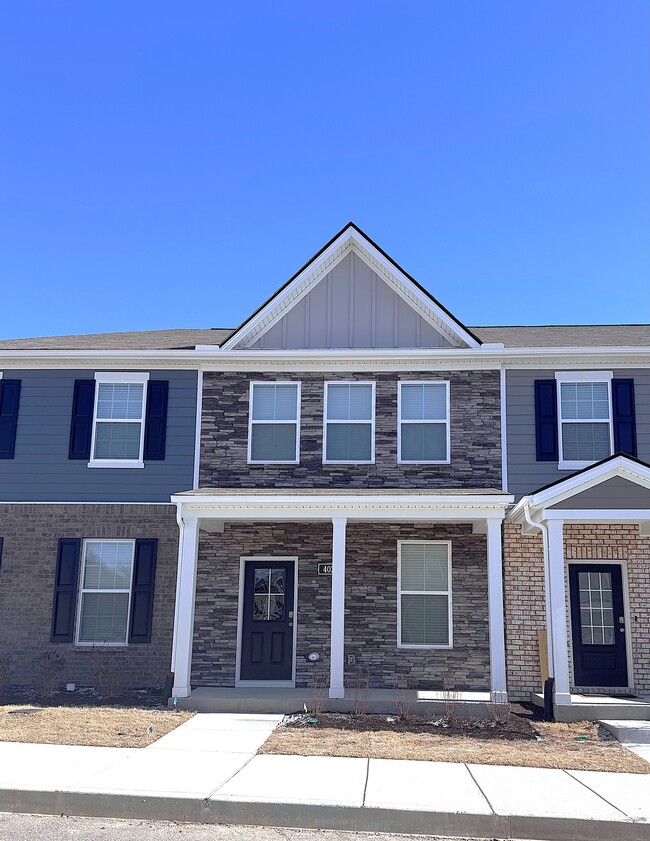 This stone front two-story townhome is brand new. It is within one block of the community pool. - 403 Augustine Dr Casa Adosada