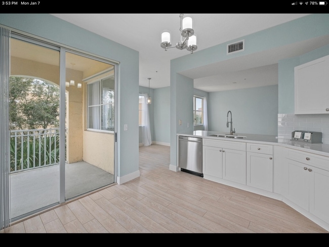 Kitchen with slider to balcony - 11041 Legacy Blvd Unit 305
