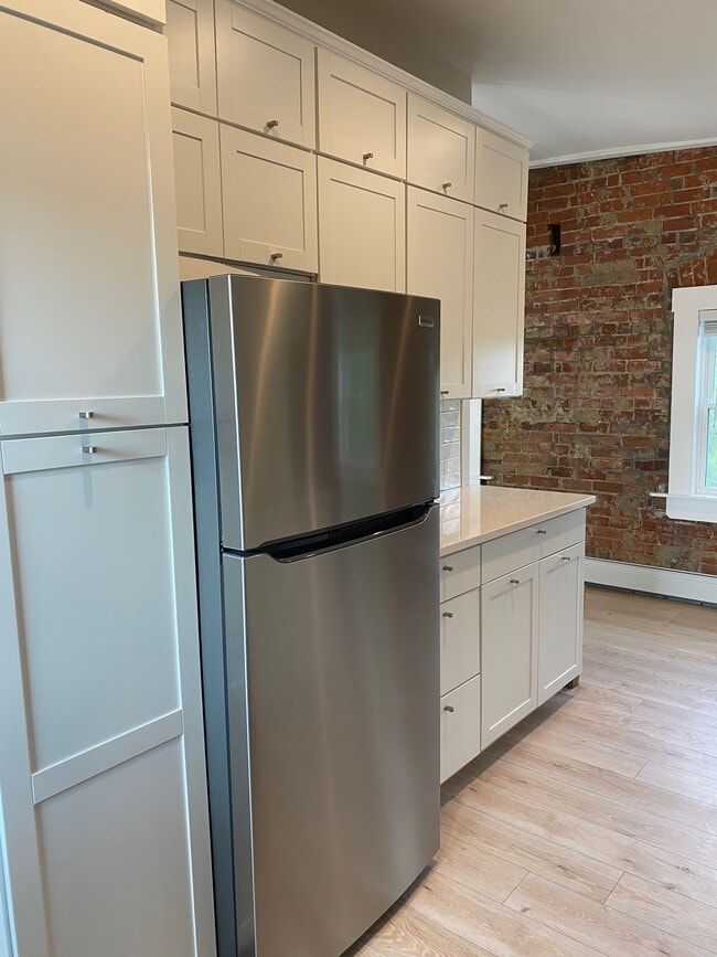 Second wall of kitchen with refrigerator and 3-story pantry - 427 Klotter Ave Unit Apartment E