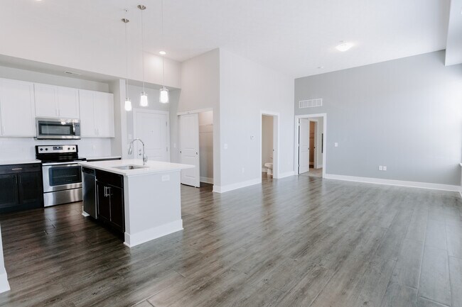 Experience modern living in this stylish open-plan kitchen and spacious living area. - The Landon at New Albany Park