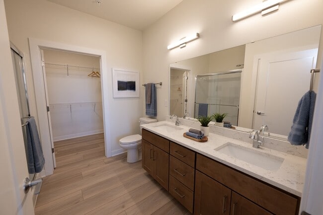 Primary Bath with Oversized Walk-In Closet - Highlands at Aero Park Apartments & Townhomes 55+