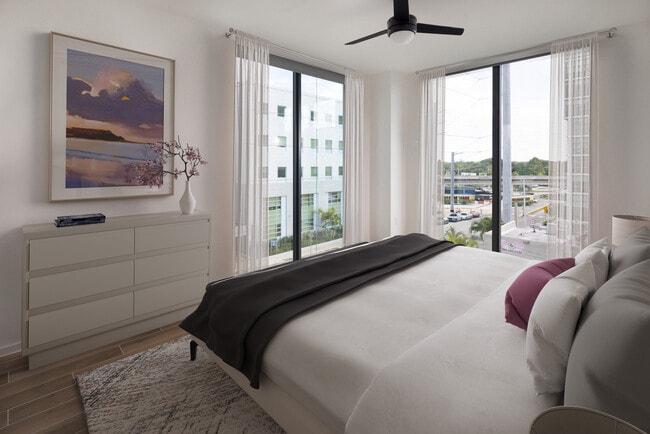 Bedroom with hard surface flooring - Avalon Merrick Park
