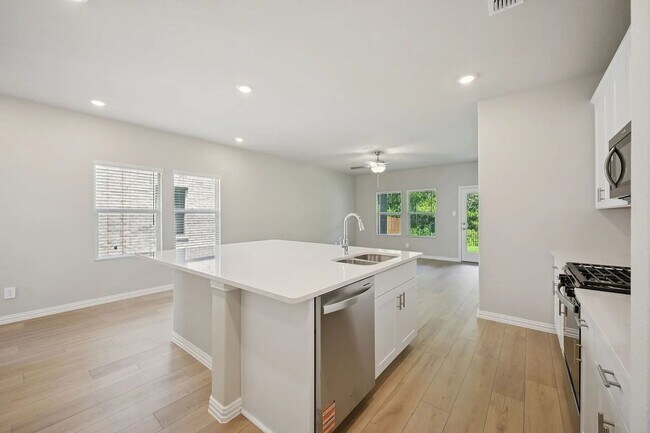 Photo - Stylish 3-bedroom home with modern kitchen, airy living spaces, vaulted primary suite, and elegan...