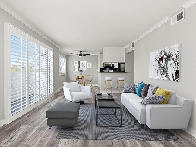 Living room with hardwood floor and large windows for natural light.
