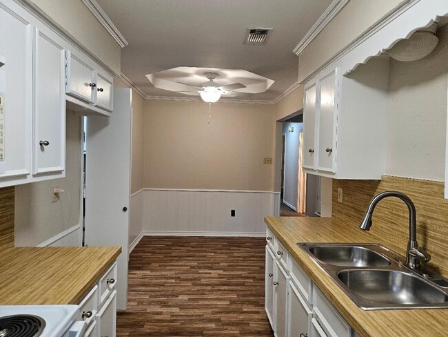 Photo - Three bedroom and two bathroom nicely remodeled with new flooring. Large wood fenced backyard