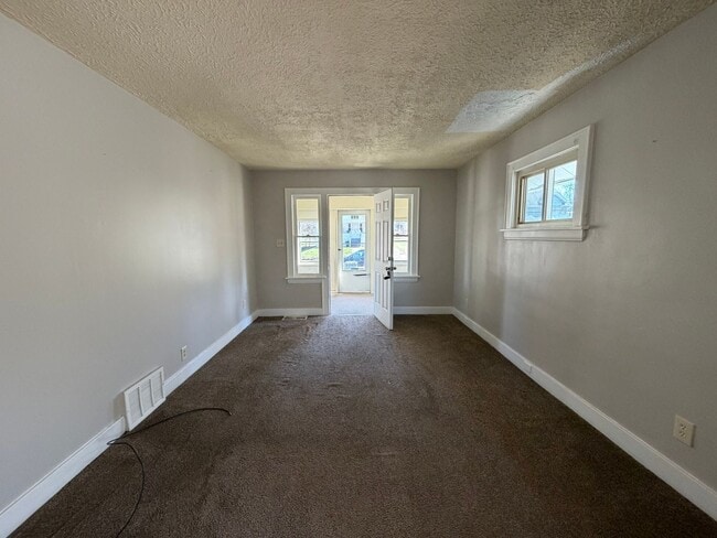 Photo - Charming 2-Bedroom Home with Secure Front Porch, Carport & Big Yard in Goodyear Heights