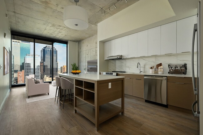 The kitchen and living room of The Hey Hay at Three Light Luxury Apartments