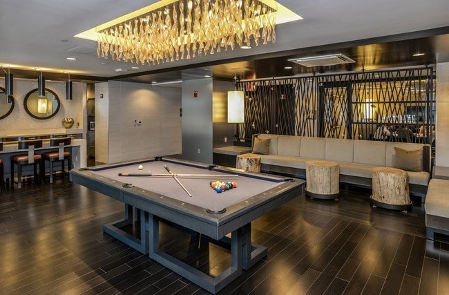 Community room with TV's and pool table at the Lex
