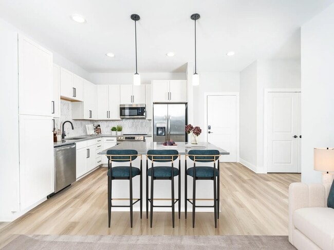 Pick your perfect look with two finish packages and enjoy a spacious chef’s island for all your cooking needs. - Modera Liberty Row