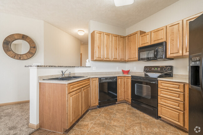 Our villas and duplexes include spacious kitchens with glass-top stoves for easy cleanup. - Stone Ridge Estates Rental