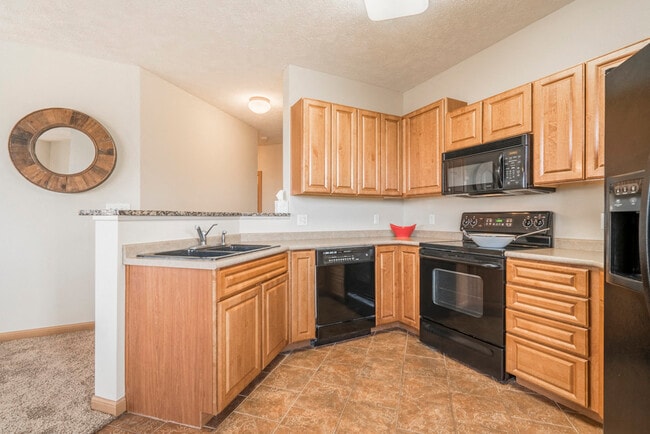 Our villas and duplexes include spacious kitchens with glass-top stoves for easy cleanup. - Stone Ridge Estates Apartments