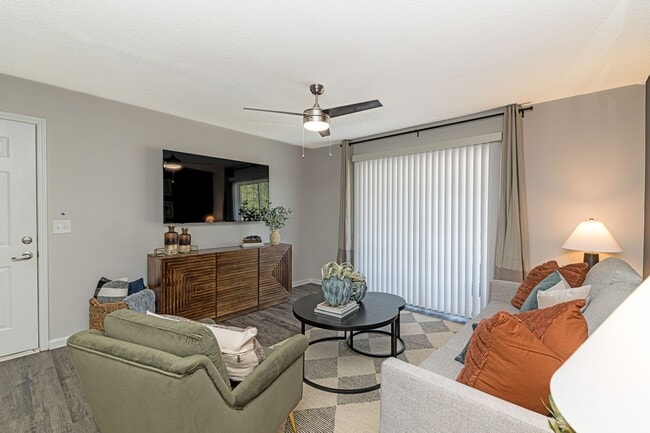 Spacious living room with hardwood-style flooring & overhead lighting