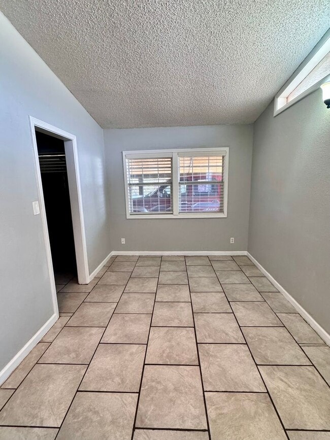 Photo - Charming 3-bedroom, 1-bath home featuring an attached carport and a fully fenced backyard—perfect...