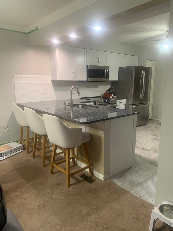 Granite countertops throughout with subway tile backsplash. And, all new higher end appliances. - 704 Carters Grove Dr