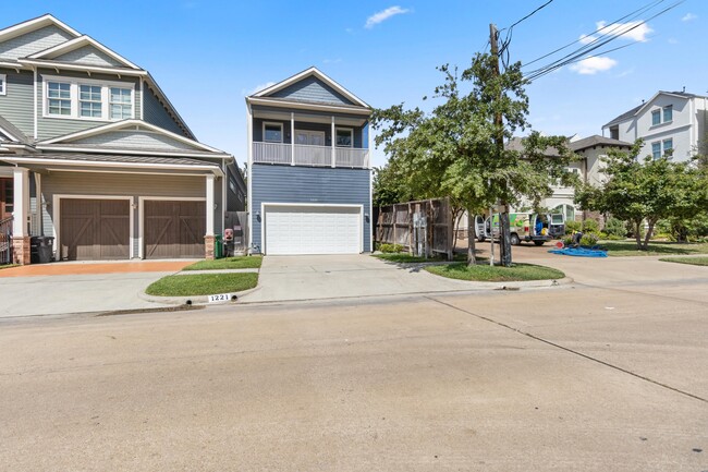 Front view from W 23rd street. House is facing South. Driveway and garage can each fit 2 vehicles - 1221 W 23rd St