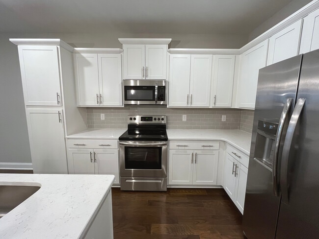 Cabinet area with Stove, Microwave and Fridge - 4000 Shadow Green Dr Unit 4102