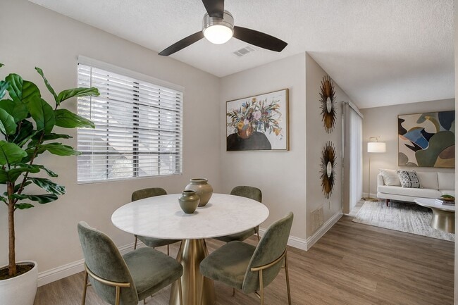 Elevate your living at Shelter Cove with this stylish dining area featuring a chic round table and modern decor. Enjoy natural light through oversized windows and a spacious layout perfect for gatherings. Schedule your tour today!