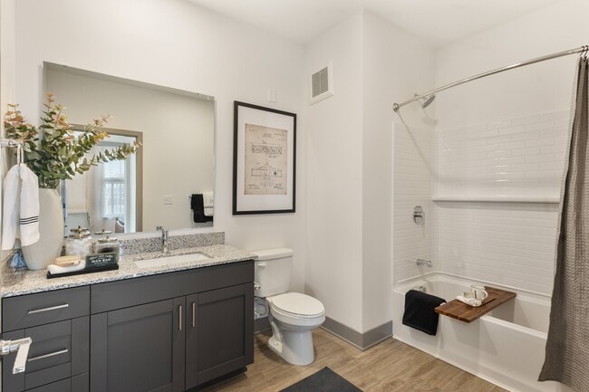 Modern model apartment bathroom with granite countertops at Montage West Lafayette. - Montage West Lafayette