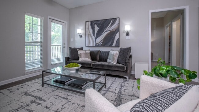 our living room features ample natural lighting and a ceiling fan, creating the perfect ambiance for your everyday retreat!