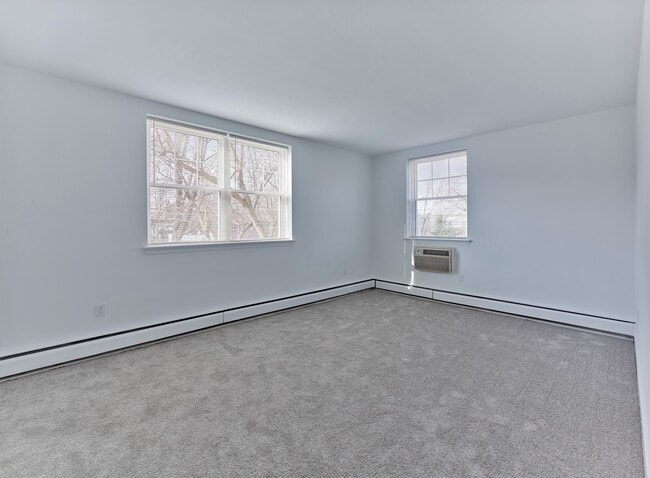 Spacious, light-filled bedroom with plush carpeting at Crestwood Apartments in Wayne, PA